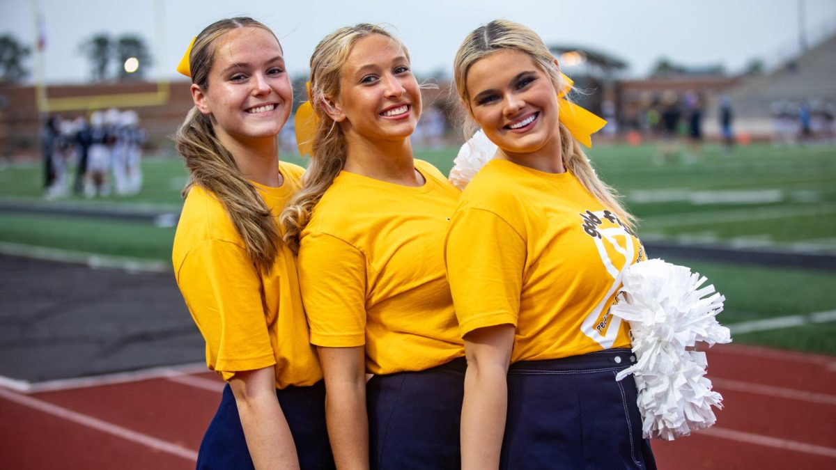 Junior cheerleaders, Courtney Thompson, Ryan Vadheim, and Brooke Altic, bring the spirit to every game. 